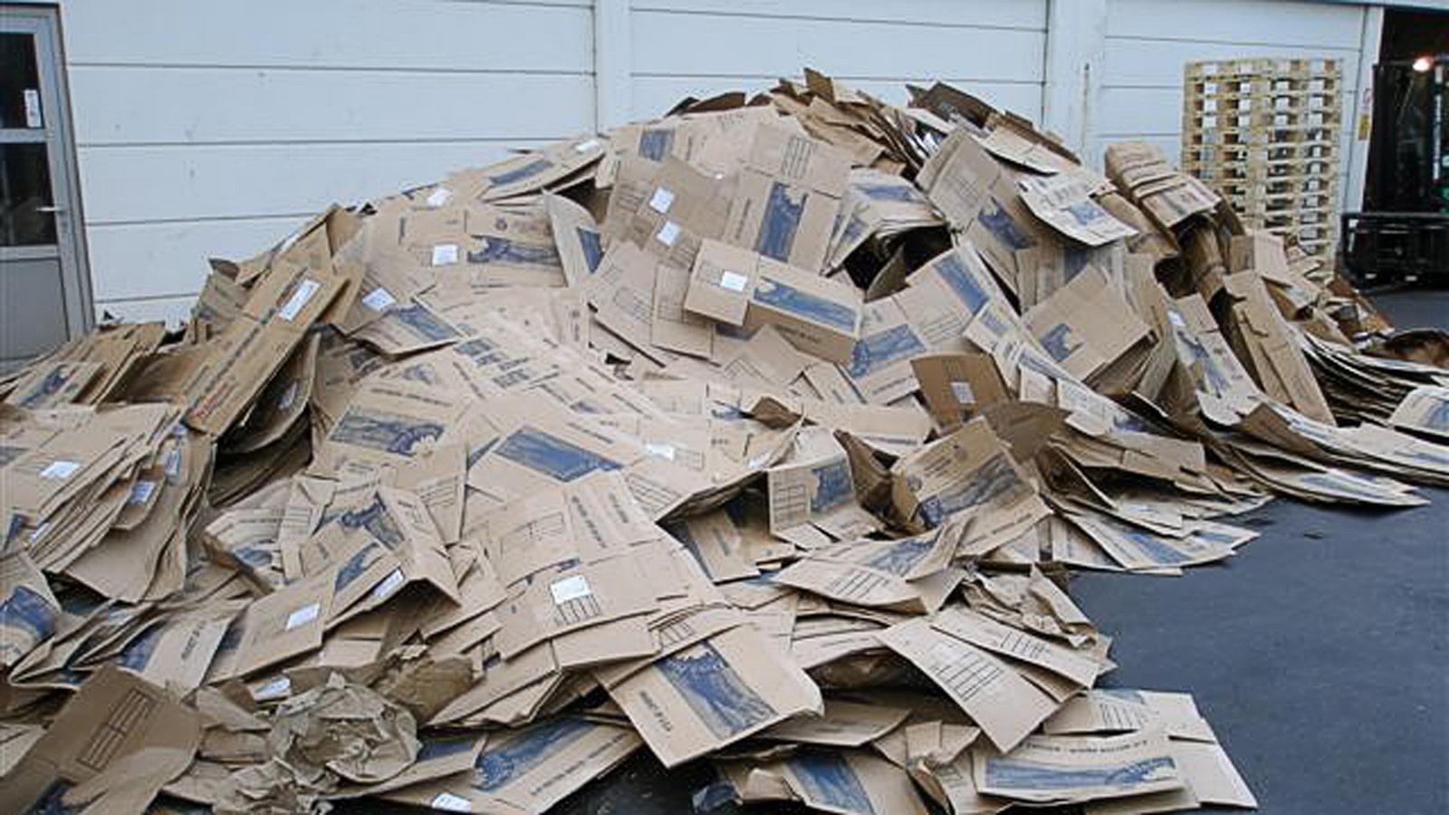 Heap of cardboard waste outside on the ground