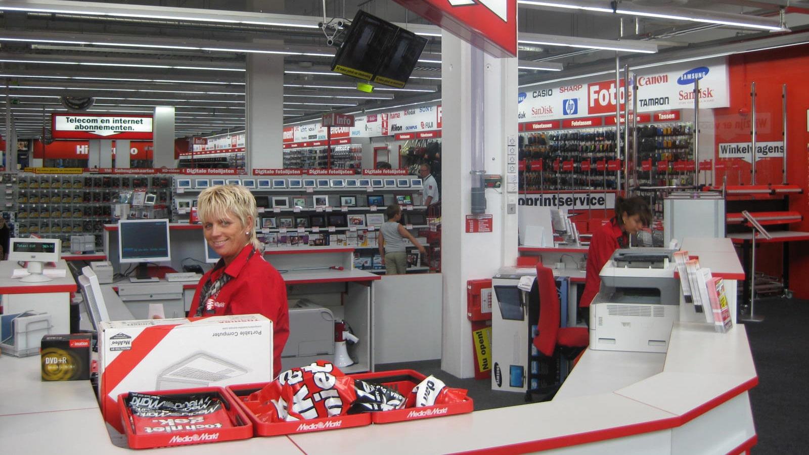 Two employees ready to help customers at Media Markt store