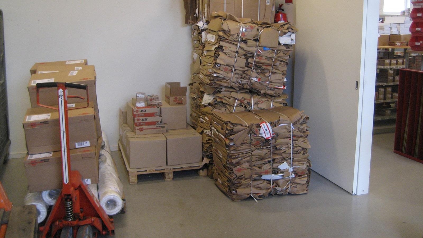 Compacted cardboard bales and boxes with goods in Würth warehouse